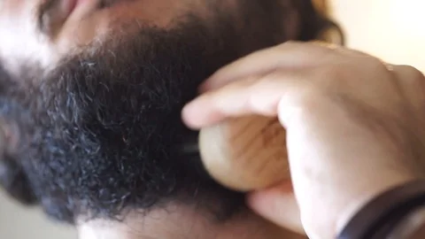 A boy brushes his beard for movember Stock Footage 95432881