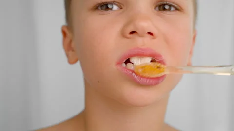 A boy brushes his teeth with a brush and toothpaste, close up. Stock Footage 278510660