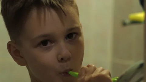 The boy brushes his teeth standing in the bathroom. close-up of the face Stock Footage 147740009