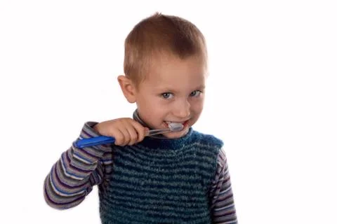 Boy brushing his teeth after bath Stock Photos