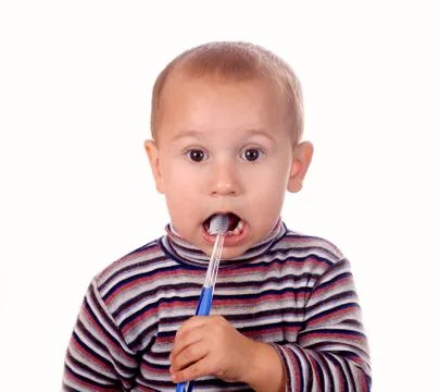 Boy brushing his teeth after bath Foto stock