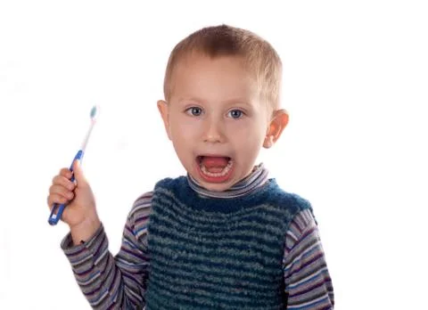 Boy brushing his teeth after bath Stock Photos