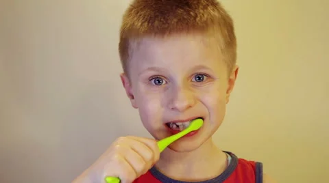 Boy brushing his teeth with a brush Stock Footage 61518871