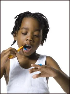 Boy brushing his teeth Stock Photos