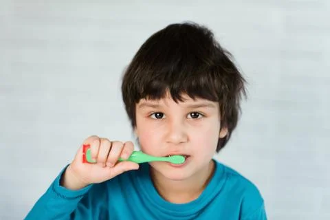 Boy brushing his teeth Stock Photos
