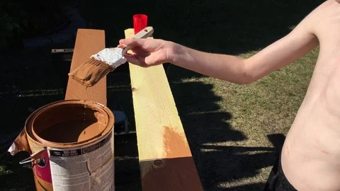 Boy Brushing on Stain Video stock 76580444