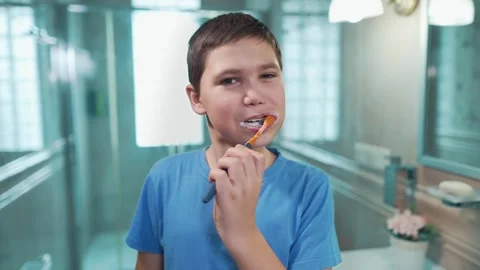 Boy brushing teeth in the bathroom Stock Footage 241436597