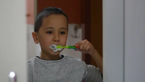 Boy brushing teeth in front of mirror. Dental health in children Stock Footage 124086583