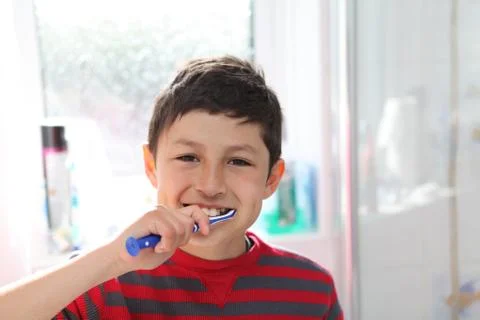 Boy brushing teeth Stock Photos
