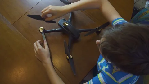 Boy building a drone, copter, from above 4k Stock Footage 105029027