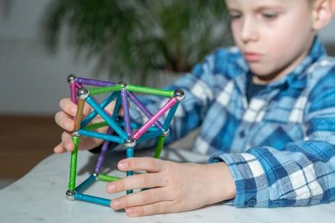 Boy Building Magnetic Structure Fotos de archivo