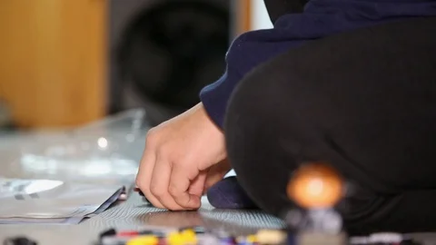 Boy building new interlocking plastic bricks toy at home Stock Footage 123507520