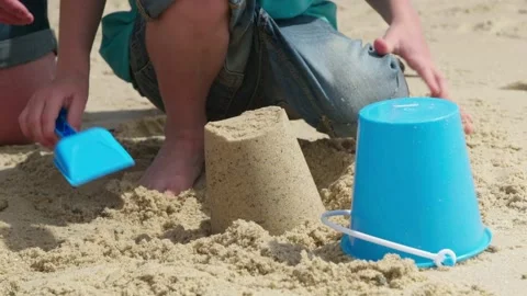Boy Building a Sand Castle on a Sandy British Beach Stock Footage 163423093