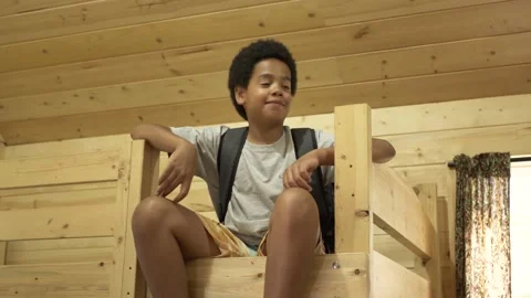 Boy on bunkbed in log cabin Stock Footage 221037578