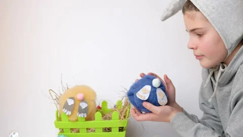 Boy with bunny ears playing with a soft toy rabbit in basket Video stock 147716981