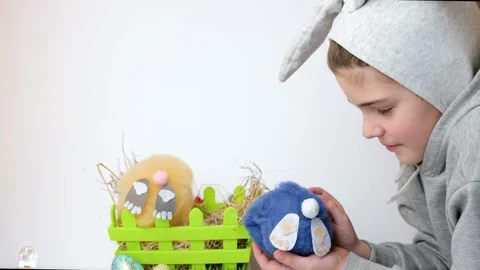 Boy with bunny ears playing with a soft toy rabbit in basket Stock Footage 147717873