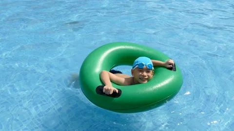 Boy on the buoy in pool Stock Footage 64640603