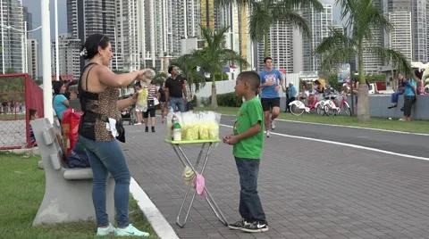 Boy buying a snack on La Cinta Costera, Panama City, Panama Stock Footage 47898973