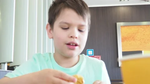 Boy in a cafe eats fast food. junk food. nuggets with sauce. like food. Vídeos de archivo 167212423