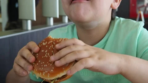 Boy in a cafe eats fast food. junk food. nuggets with sauce. like food. Vídeos de archivo 167212433