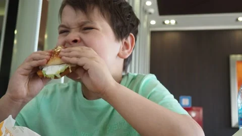 Boy in a cafe eats fast food. junk food. nuggets with sauce. like food. Vídeos de archivo 167212509