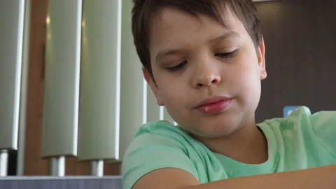 Boy in a cafe eats fast food. junk food. nuggets with sauce. like food. 스톡 동영상 167212632