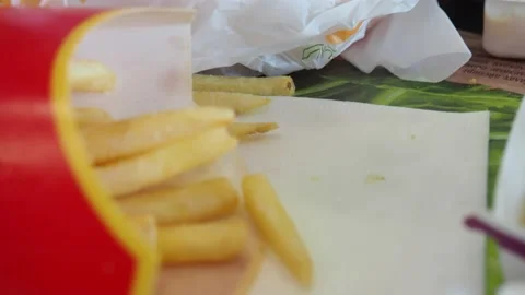 Boy in a cafe eats fast food. junk food. nuggets with sauce. like food. 스톡 동영상 167212686