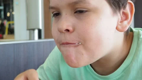 Boy in a cafe eats fast food. junk food. nuggets with sauce. like food. 스톡 동영상 167212687