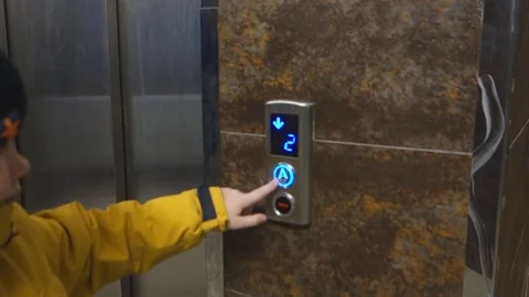 The boy is calling the elevator Stock Footage