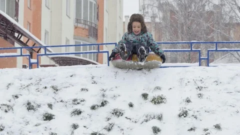 The boy came down the hill on snow tube Stock Footage 91492964
