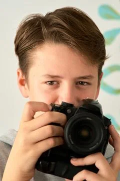 A boy with camera in his hands Stock-Fotos