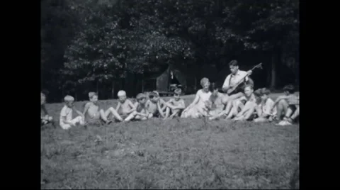 Boy campers listening to music at campsite Stock Footage