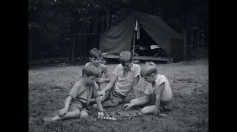 Boy campers playing board game at campsite Stock Footage 44575802
