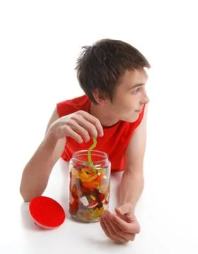 Boy with candy snake looking sideways Stock Photos