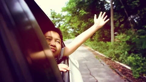 Boy in car waving hand during travel Stock Footage 78719150