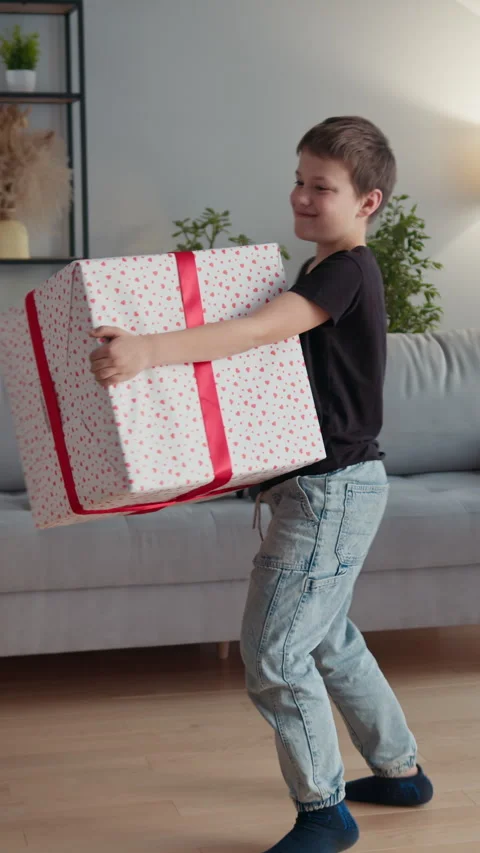 Boy Carries Large Gift Box Stock Footage 335485618
