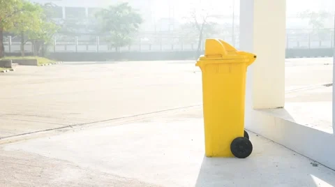 Boy carry garbage bag and drop in the yellow bin Stock Footage 59764467