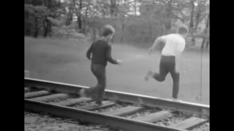 Boy catching up friend, running quickly against summer nature backdrop. Active Stock Footage 270723143