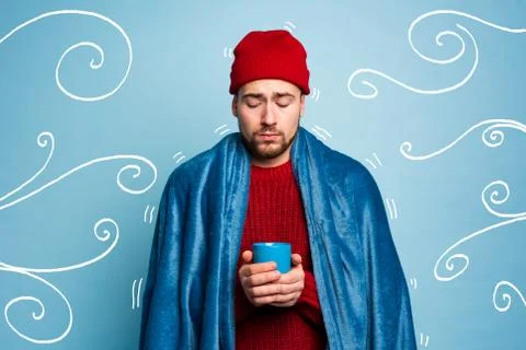 Boy caught a cold and drinks hot the. Cyan background. Concept of illness Foto stock