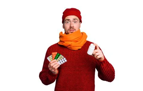 Boy caught a cold and uses pills to heal. Studio on Cyan background Stock Photos
