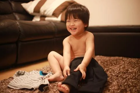 Boy changing clothes Stock Photos