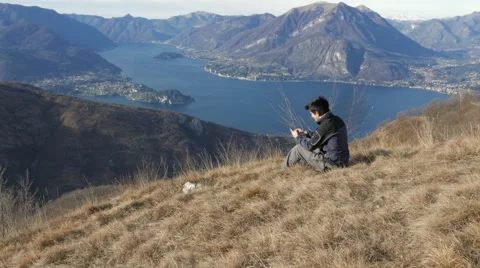 Boy chat with your cell phone in the mountains Stock Footage 59693121