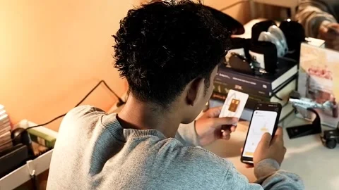 A boy is checking gold price charts on a smartphone Stock Footage 321691685