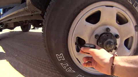 Boy checking tyre pressure, offroad car Video stock 108753626