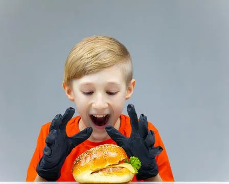 The boy with the cheeseburgers Stock Photos