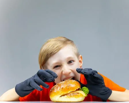The boy with the cheeseburgers Stock Photos