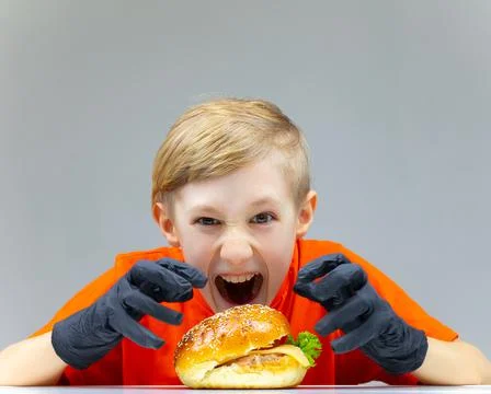 The boy with the cheeseburgers Stock Photos