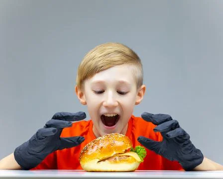 The boy with the cheeseburgers Stock Photos