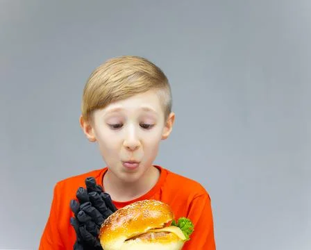 The boy with the cheeseburgers Stock Photos
