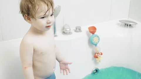 Boy child bathes in bath Stock Footage 129568525